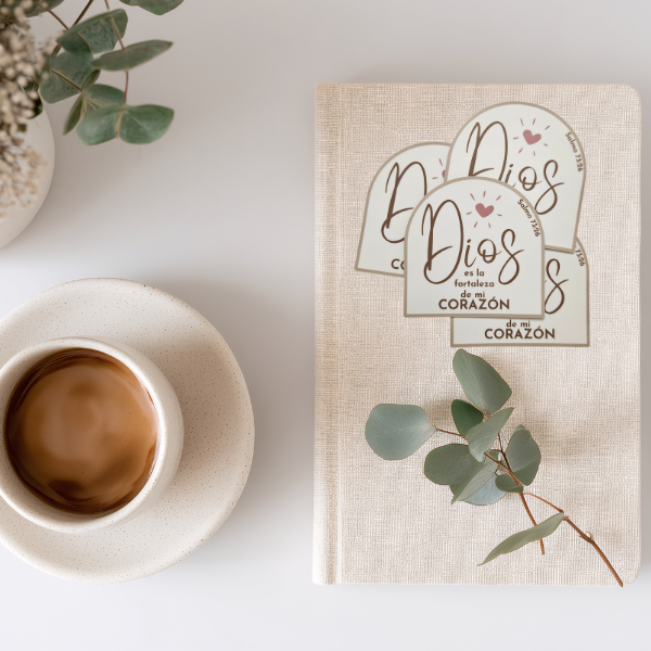 Notebook with motivational stickers and a cup of coffee on a light surface